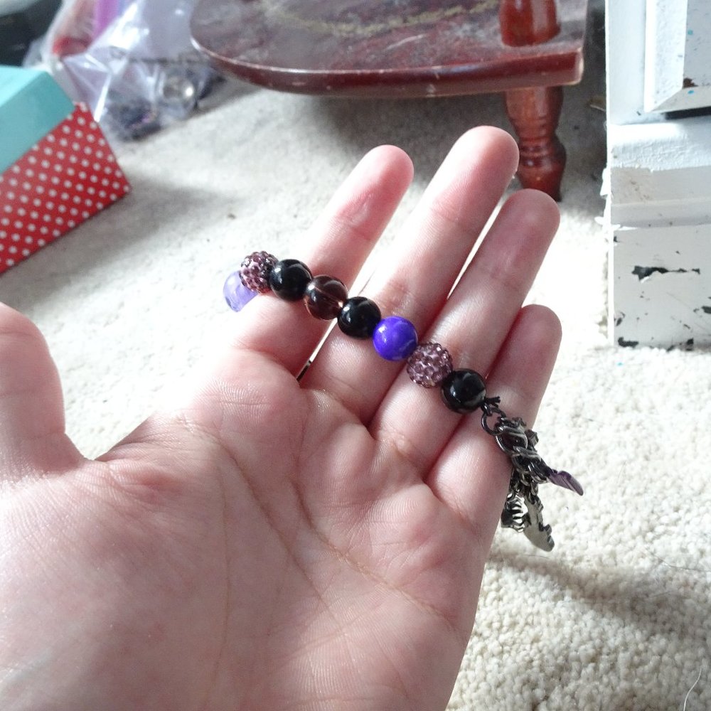 purple and black charm bracelet